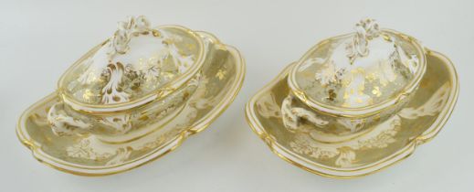 A pair of early 19th century hand-painted Davenport sauce tureens and covers on fixed stands, c.