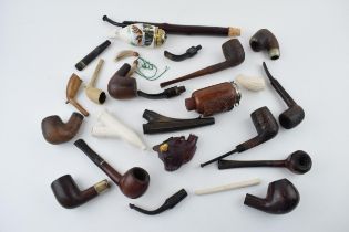 A collection of vintage tobacco smoking pipes to include briar, clay and ceramic examples in varying