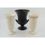 A pair of Wedgwood Queensware trumpet vases, 22cm tall, one pink on white (hole drilled to base),