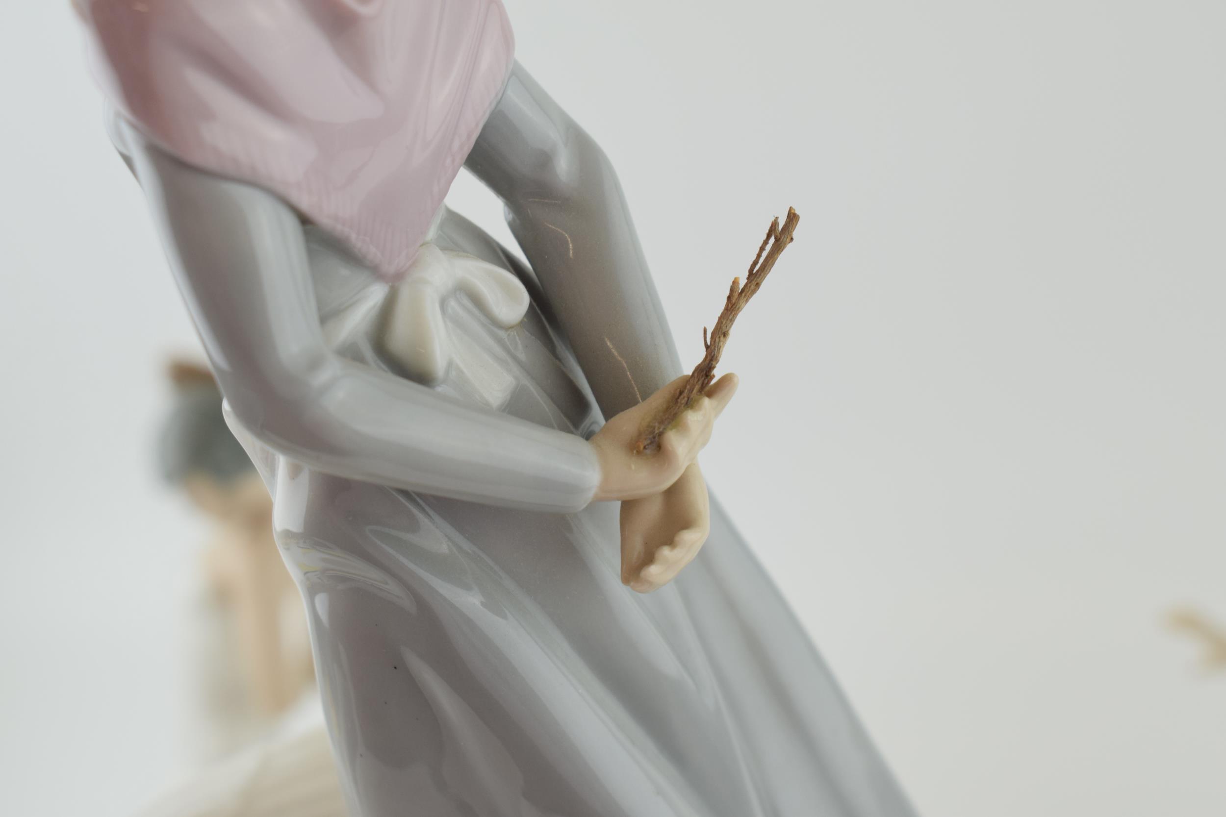 A trio of figures to include a Lladro girl 4820 with a Nao girl with geese and a girl in a frilly - Image 4 of 5