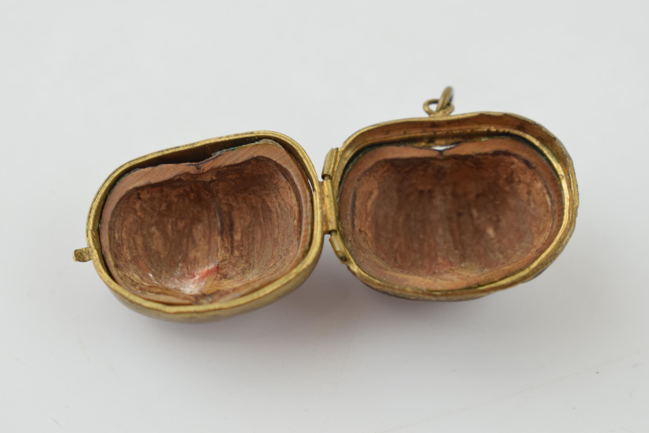 A miniature purse made form a hazelnut shell with brass hinge and mount. 2.5cm. - Image 3 of 4