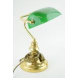 A bankers lamp with brass base and green glass shade. Height 36cm.