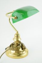 A bankers lamp with brass base and green glass shade. Height 36cm.