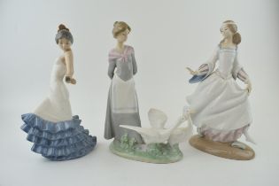 A trio of figures to include a Lladro girl 4820 with a Nao girl with geese and a girl in a frilly