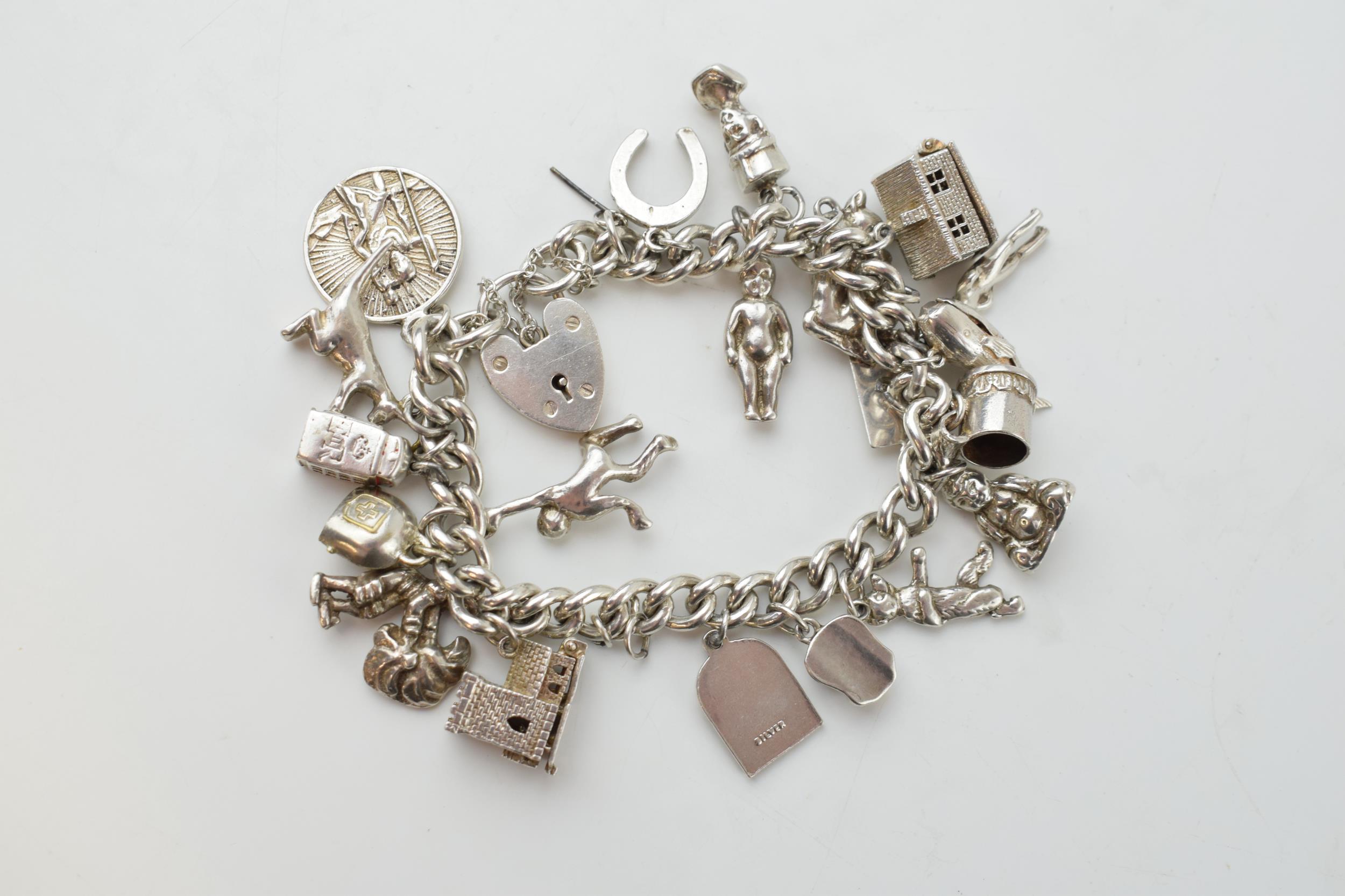 Silver charm bracelet with a church, a bear, people, a tankard and others, 81.6 grams. - Image 4 of 4