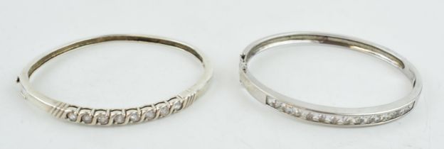 A pair of sterling silver and stone set bangles, 35.0 grams (2).