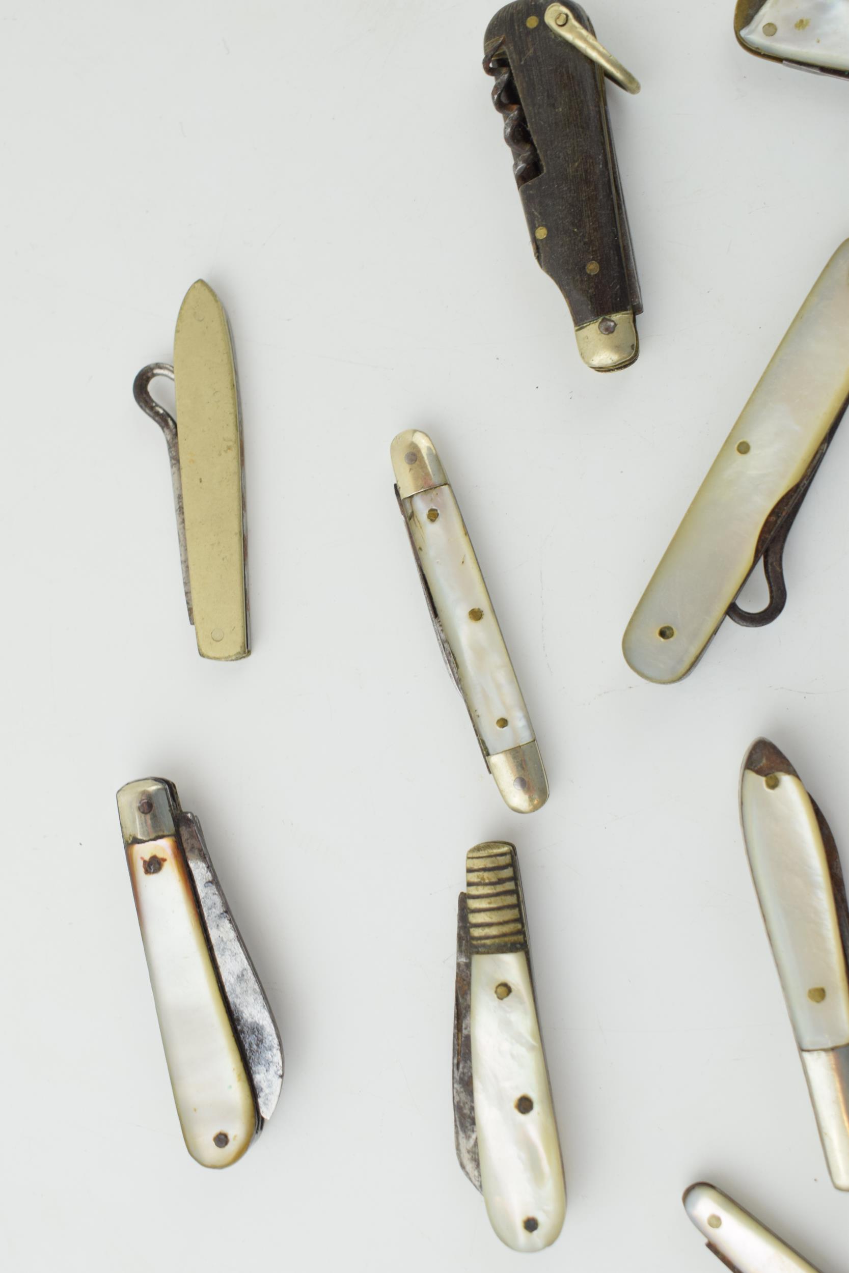 A collection of antique multifunction tool pocket knives to include mother pot pearl handled example - Image 7 of 9