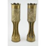 A pair of Trench Art vases, 34cm tall, shaped edges, leaf decoration.
