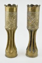 A pair of Trench Art vases, 34cm tall, shaped edges, leaf decoration.