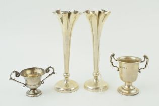A pair of loaded silver bud vases, 14cm tall, with a silver miniature trophy and a continental