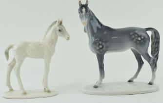 A pair of continental pottery horse figures to include a dappled grey example facing left by
