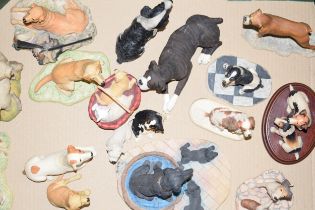 A collection of Border Fine Arts dog figures to include Jack Russells, Spaniels, Golden Retrievers