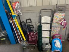 An assortment of items including , stepladder , ironing board, metal bins