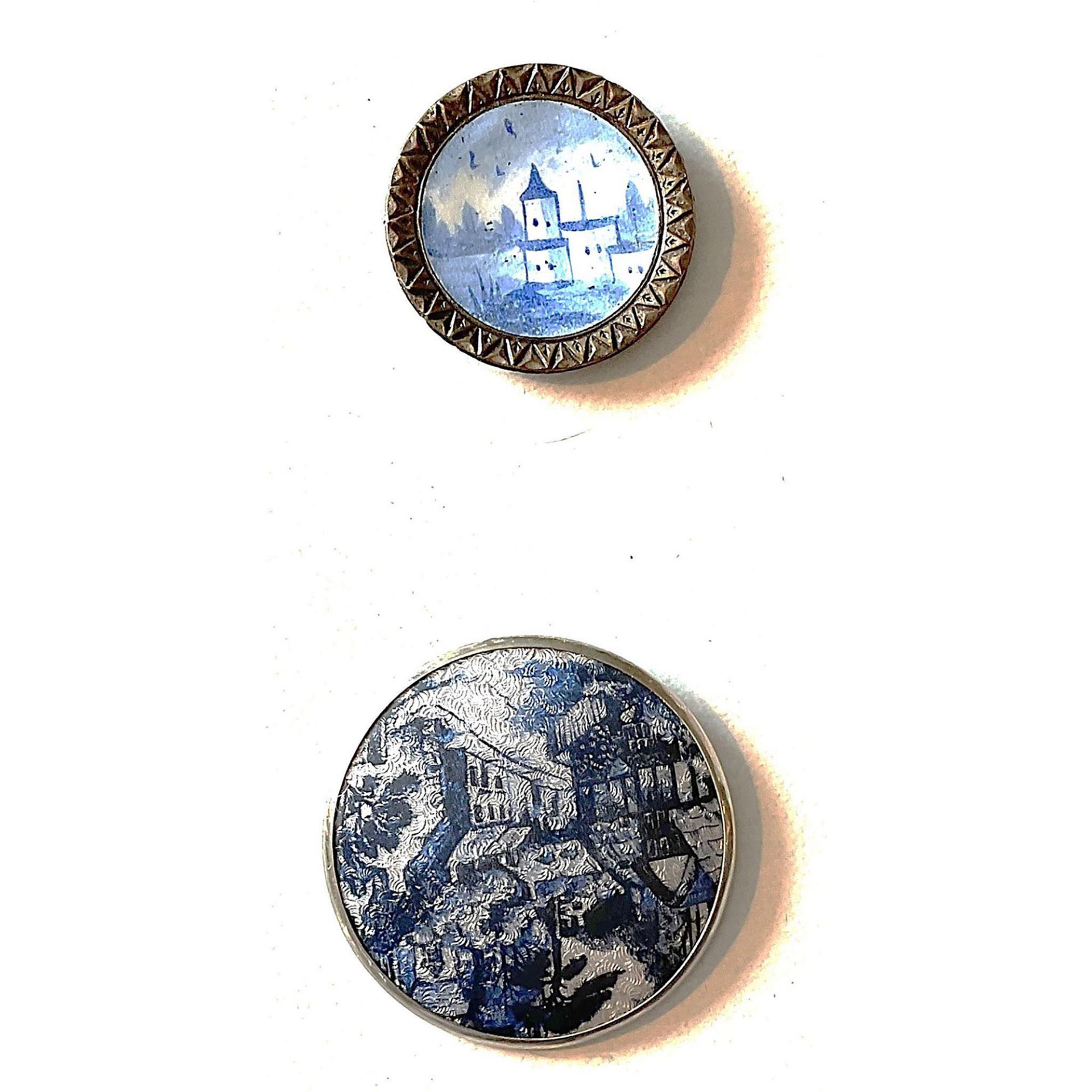 A small card of blue and white enamel buttons