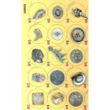 A partial card of assorted pewter buttons including pictorial