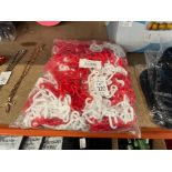 BAG OF NEW RED AND WHITE PLASTIC SAFETY CHAIN