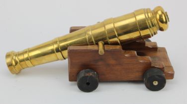 Brass barrel cannon on wooden carriage measures 14 inches overall heavy.