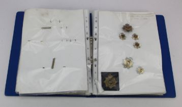 Blue folder of ASC / RASC / RCT cap badges, shoulder titles, collars, metal and cloth. (qty)