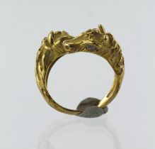 Yellow gold (tests 18ct) double horse head torque ring, head horse head, diamond set eye, finger