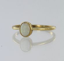 Yellow gold (tests 18ct) vintage opal solitaire ring, oval opal cabochon measures 6mm x 5mm,