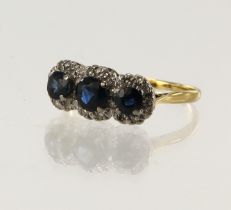 Yellow gold (tests 18ct) diamond and teal sapphire triple cluster ring, three round sapphires