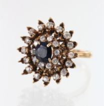 Yellow gold (tests 9ct) sapphire and CZ cluster ring, one oval sapphire measures 6.5mm x 5.5mm,