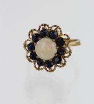 9ct yellow gold opal and sapphire cluster ring, one cabochon opal measuring 8mm, surrounded by