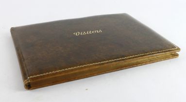 Queen Elizabeth & Prince Philip. A leather bound vistors book signed at the front in ink by Queen