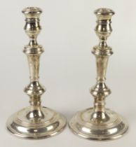 Silver pair of candlesticks, hallmarked 'RG, London 1971', weight bases, height 25cm approx.