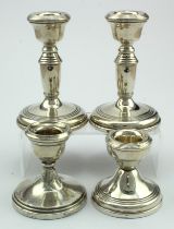 One pair of silver dwarf candlesticks along with two other different silver dwarf candlesticks,