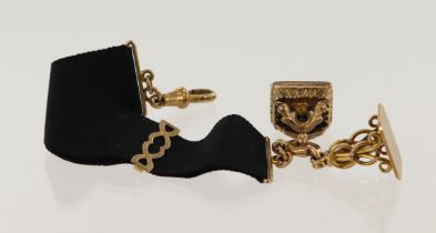 Antique 9ct yellow gold black ribbon fob strap, with one 9ct gold fob and one yellow metal fob,
