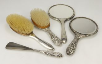 Mixed lot of four dressing-table silver backed items comprising two mirrors and two hair brushes,