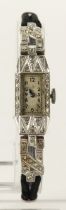 Ladies platinum cased cocktail manual wind wristwatch. The silvered dial with Arabic numerals, art-