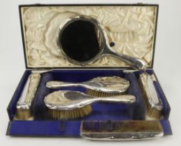 Silver vanity set, comprising four brushes, mirror and comb (slight damage to comb), hallmarked 'H.