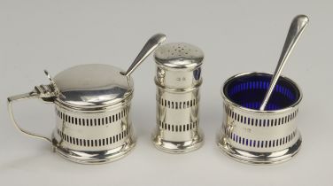 Three piece silver cruet set comprising salt pot, mustard pot and pepper pot with two blue/glass