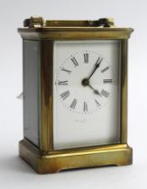 Brass five glass carriage clock, white enamel dial with Roman numerals, with makers name beneath (