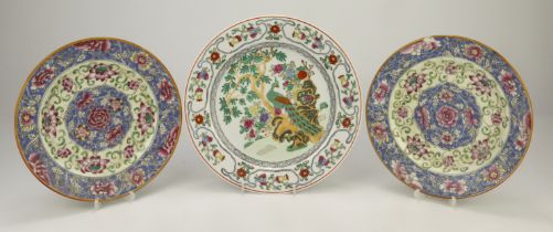 Famille Rose pattern plates. The first depicting a peacock in a garden.Measures approx 25.5cm dia.