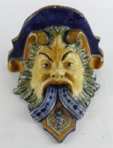 Majolica wall bracket, depicting an unusual looking figure surrounded by foliage, circa late 19th to