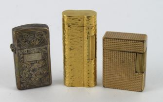 Lighters. Three various lighters, comprising a S T Dupont gold plated lighter, Dunhill gold plated