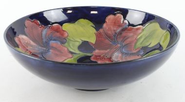 Moorcroft Hibiscus pattern bowl, makers label and signed to base, diameter 26cm, height 8.5cm