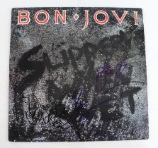 Bon Jovi. A signed 33rpm record album by Bon Jovi 'Slippery When Wet', signed in ink by four members