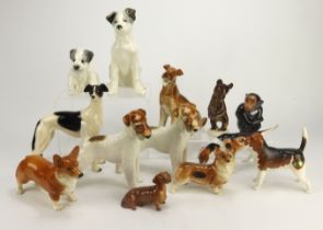 Figures. A collection of thirteen ceramic animal figures, mostly depicting dogs, makers include