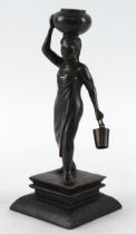 Bronze depicting an African woman carry a bowl on her head a bucket in her hand, unsigned, mouted on