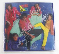 Rolling Stones. A signed 33rpm record album by the Rolling Stones 'Dirty Work', signed in ink by all