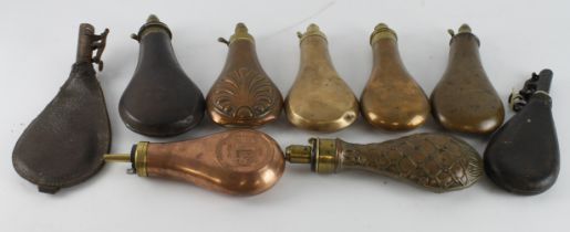 Copper and leather 19th century powder and shot flasks eight of.