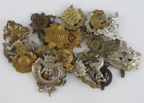 Cap Badges: A good group of 20 different cap badges, mixed periods with no apparent restrikes.