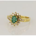 18ct yellow gold diamond and emerald cluster ring, emerald measures 6 x 4mm, round brilliant and