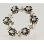 White gold (tests 18ct) diamond and sapphire floral wreath brooch, set with single cut diamonds, TDW