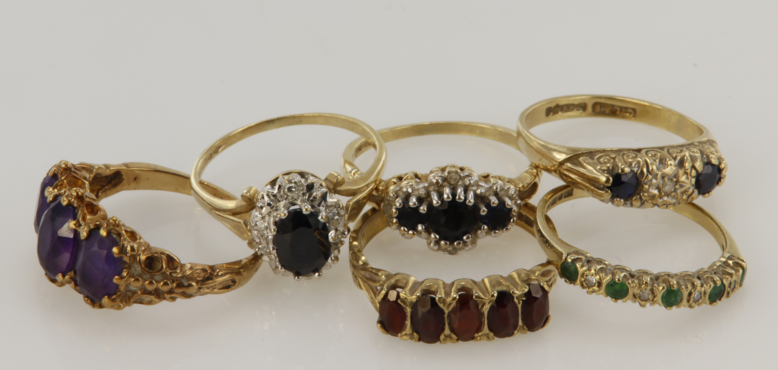 Six 9ct gold/tests 9ct rings, stones include diamond, sapphire, emerald, garnet, finger sizes Lx4,