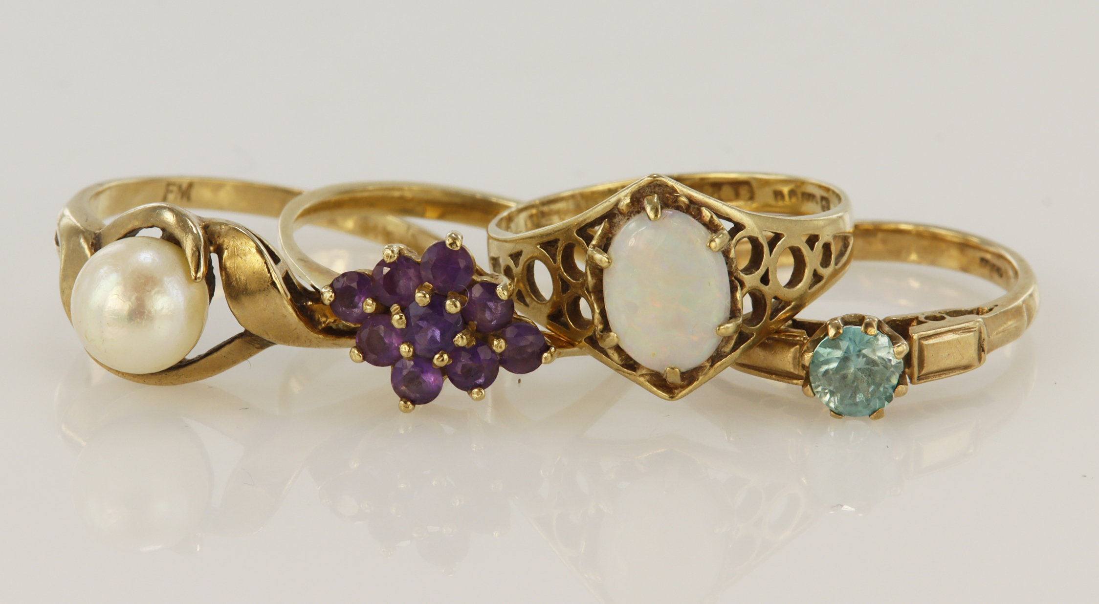 Four 9ct gold/tests 9ct rings, stones include opal, amehtyst, cultured pearl, zircon, finger sizes